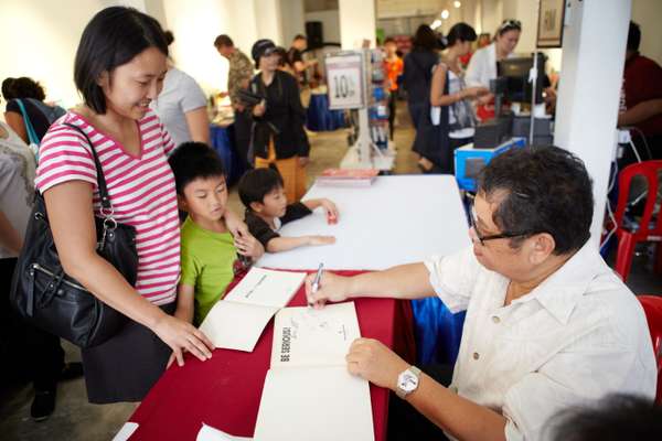 Lat chats with readers and signs books at the George Town Literary Festival in Penang
