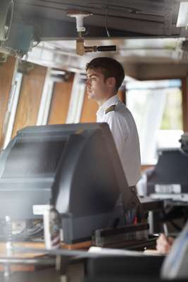 The ship’s pilot, Gabriel Baylous, at the helm
