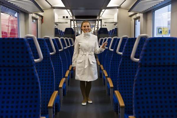 An attendant shows off the German DB Inter Regio-train by Alstom