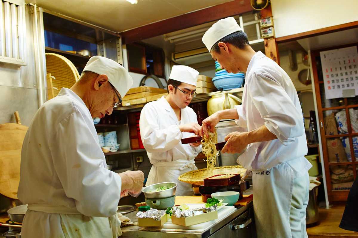 Chefs work at a low table