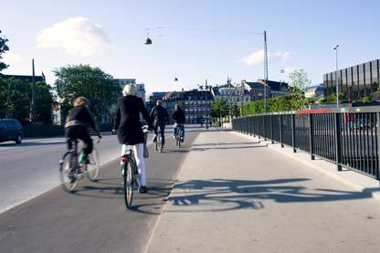 Bikers on a bridge by the national bank