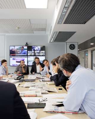 Calabresi at a morning meeting with his section editors