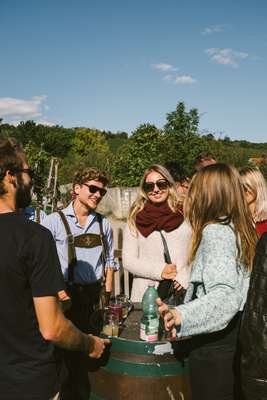 Drinking half-fermented wine (‘Sturm’) on a barrel during harvest