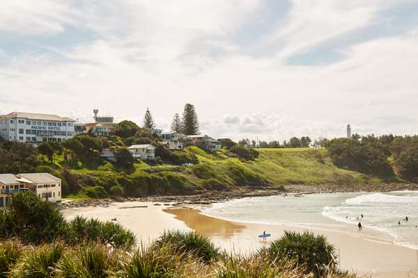 The Pacific Hotel presides  over Main Beach