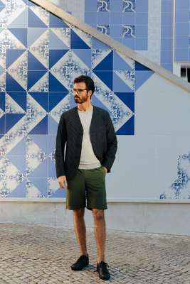 Jacket by Oliver Spencer,  jumper by Circolo 1901, shorts  by Goldwin, trainers by amb, glasses by Persol