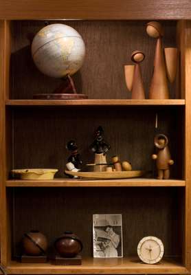 Products for sale including teak figures (top right) by Denmark’s Basse, and kayak and Eskimo by Arne Tjomsland (middle shelf)