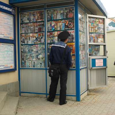 Sailor browses at a magazine kiosk