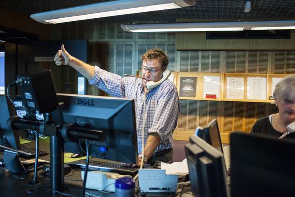 Producer Steven Turner gives the thumbs up from the control room at ABC Radio National