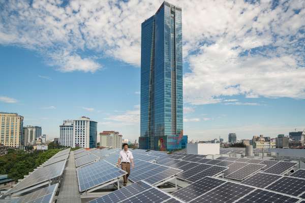 The roof of the newly built UN office is lined with solar panels and overlooks the Lotte skyscraper 
