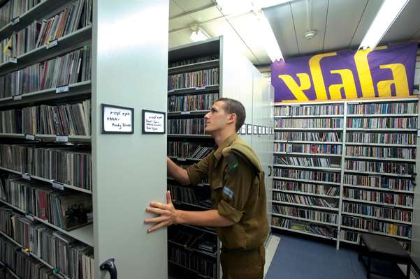 A soldier peruses the record library 