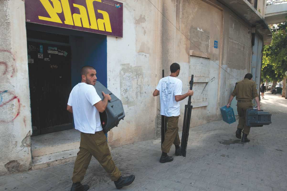 Israeli soldiers carrying audio equipment outside Galgalatz