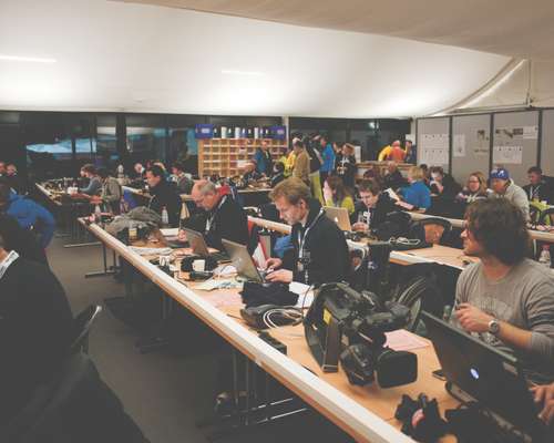 Hahn and other journalists work in the press area after the last jump