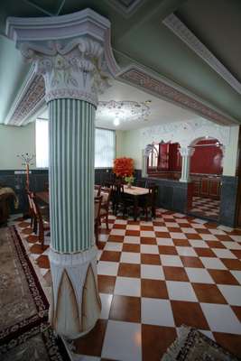 The basement in Hamkar's house has elaborate columns and plastic flowers