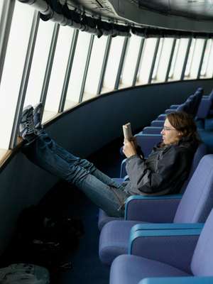 A passenger reads in the forward lounge