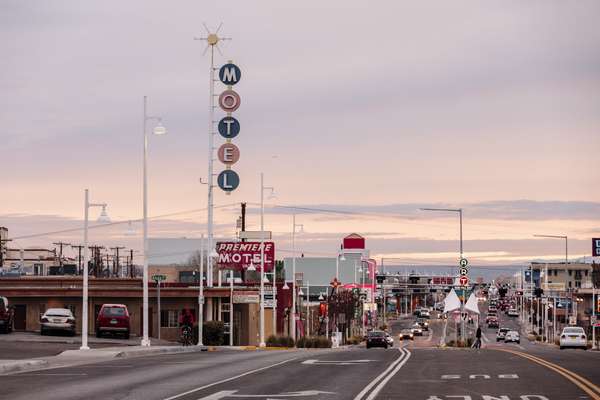 View towards Albuquerque along the  old Route 66, with some of its surviving neon motel signs