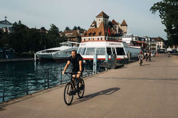 Cyclist besides Lake Annecy