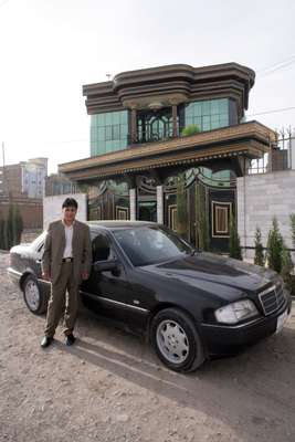 Mohammad Zaher Faqiry outside his almost complete mansion in Herat