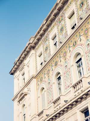 Mosaic-adorned façade of the Austro-Hungarian-era Prefecture in Piazza Unità D’Italia