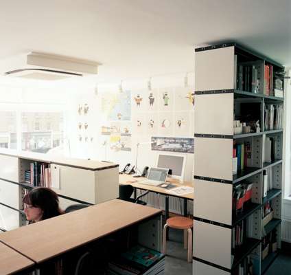 Novex shelving is used to divide the office space, Artek stools are on hand for desk guests