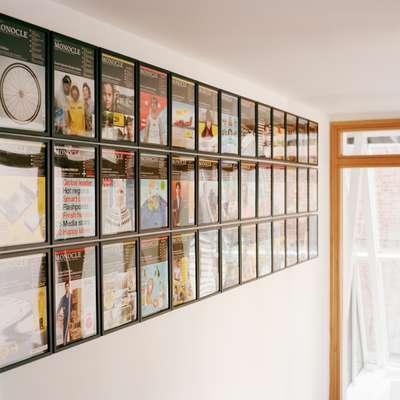 The entrance to Monocle’s floor is decorated with an up-to-date wall of the magazine’s covers
