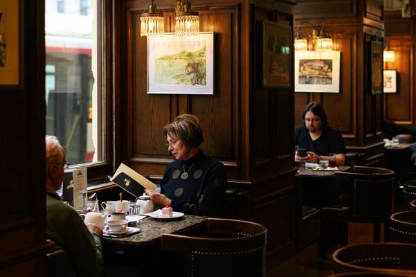 Perusing the menu at Café Schwarzenberg 