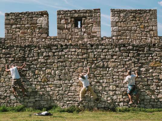 Rock climbers training at Kalemegdan Fortress high above the city 