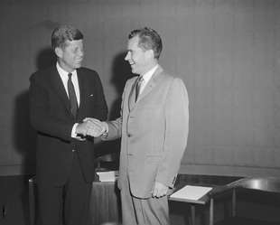 JFK, ever a style leader, appears on television wearing a two-button suit. A global trend ensues. 