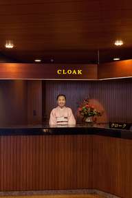 Cloakroom attendant in the now-closed main wing 
