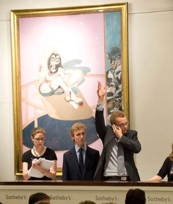Telephone bids are relayed into the Sotheby’s sale room under the watchful gaze of a Francis Bacon
