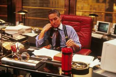 Financiers' flashy ensembles were on show in 'Wall Street'; think pinstriped suits, braces and tie-pins.