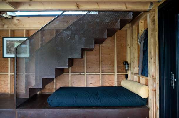 Futon and metal stairs, Enough House