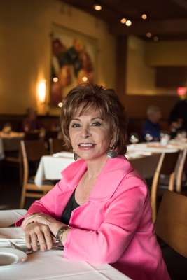 Isabel Allende at window table