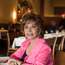 Isabel Allende at window table