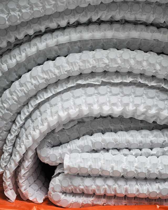 Springs are welded into pocketed sheets ready to be placed in mattresses