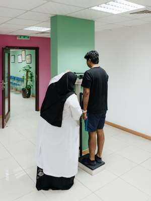 Patient’s weight being measured at the Qatar Diabetes Association 