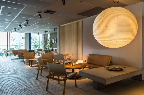 Lounge area with Akari light and Finn Juhl’s Japan Sofas; chairs by Jasper Morrison and Wataru Kumano for Nikari 