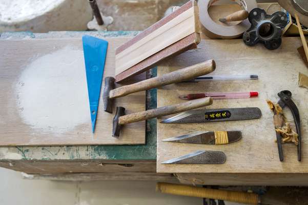 Dried papier mâché requires hammers and knives