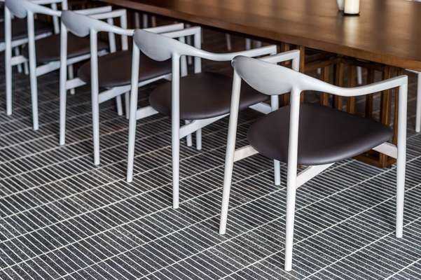 Jari dining chairs in private dining room by OEO for Brdr Krüger; brick-tile flooring by Kunishiro