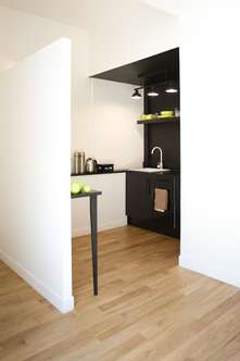 Small corner kitchen with black-stained oak surfaces