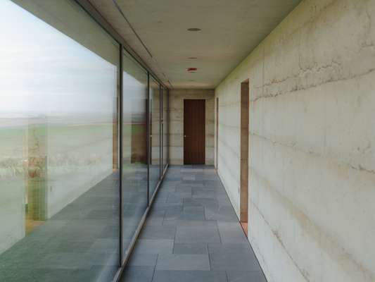 This long corridor with plate-glass windows defines the space