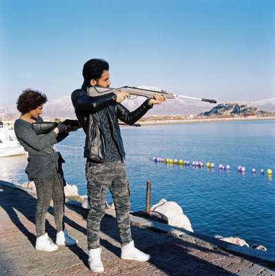 Iranian friends shooting balloons by the lake