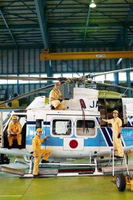 Mechanics with a Bell 412 helicopter at Hiroshima Air Station