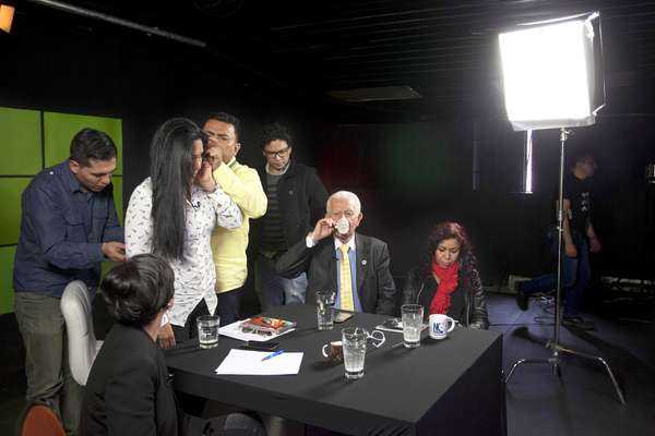 Presenter Marilu Ramirez (standing) with guests inside the NC Noticias studio