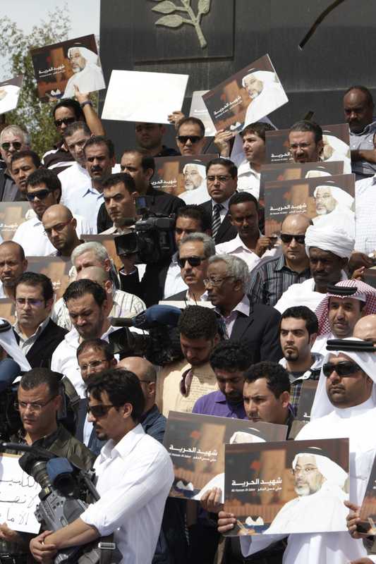 Staff gather at the memorial to Ali Hassan Al Jaber, an Al Jazeera cameraman killed in Libya