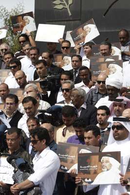 Staff gather at the memorial to Ali Hassan Al Jaber, an Al Jazeera cameraman killed in Libya