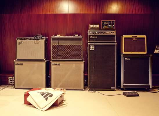 Vintage amps warm up next to the studio’s wooden walls