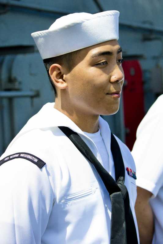 Asian-American crew members report to the flight deck to greet their Hong Kong guests
