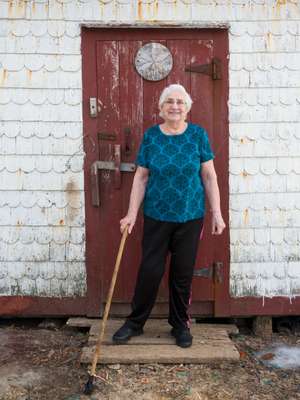 A resident of Barr’d Islands community outside her husband’s shed