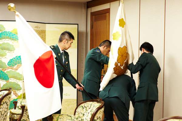 GSDF staff setting up the meeting room with flags