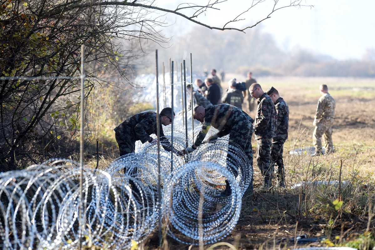 12 November 2015: Slovenian soldiers laying barbed wire across the Slovenian-Croatian border close to Rakovec 